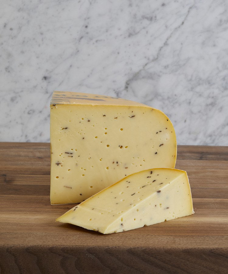 Truffle Gouda wheel and freshly cut wedge